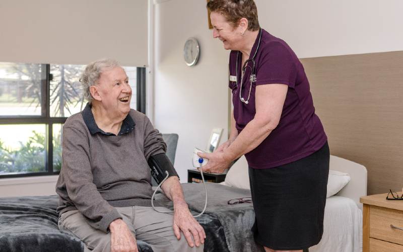 Aged care reform 2025 | Nurse takes the blood pressure of an aged care resident