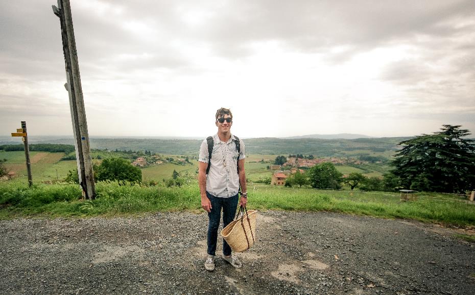 young man standing in green landscape