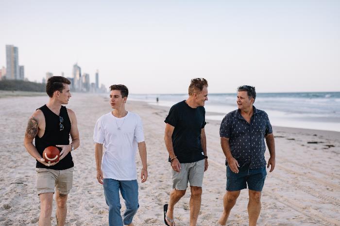 Group of men walking on the beach