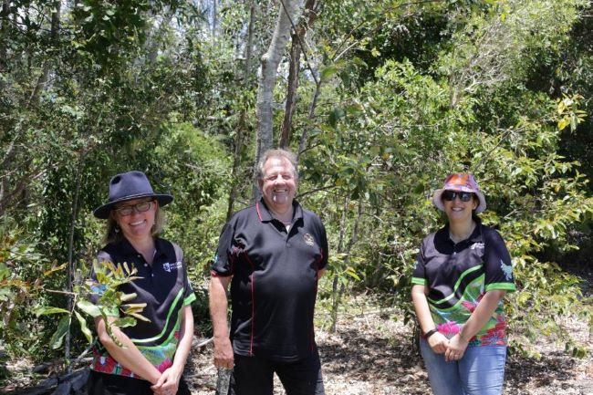 three people standing in the bush